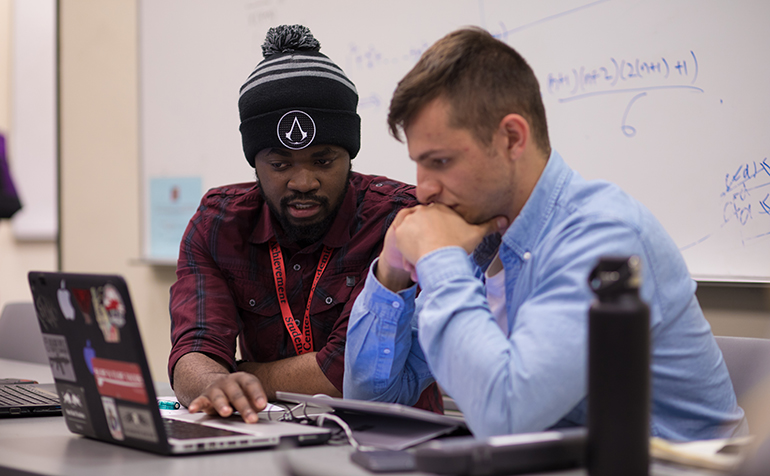 Two male students work together studying