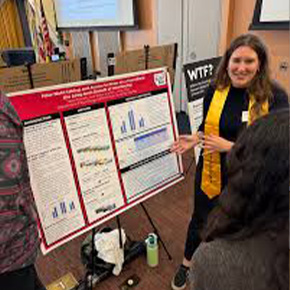 student standing with poster board 