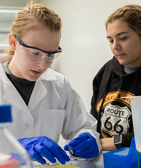 Two female students working in a lab