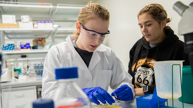 Two female students working in a lab
