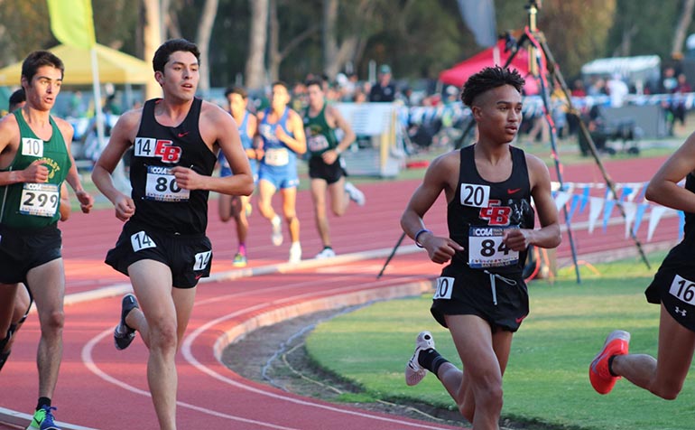 Male runner competes on track