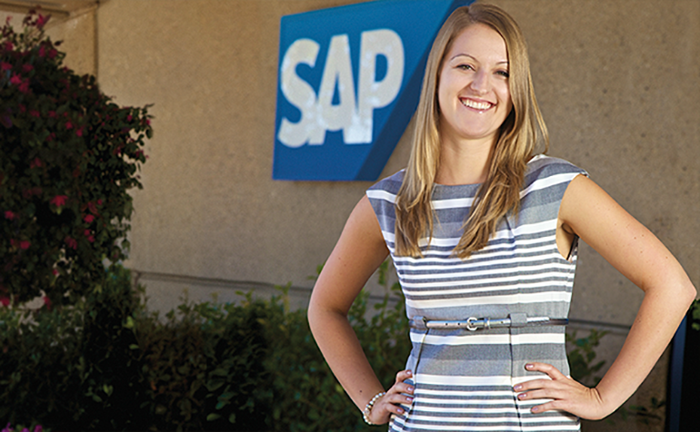 Blonde woman standing in front of SAP sign