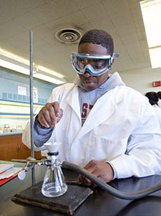 Student in goggles working in a lab