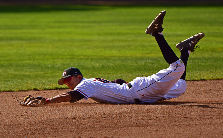 Baseball player diving for a ball