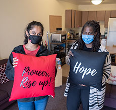 Students holding up "Pioneers for HOPE" cushions  