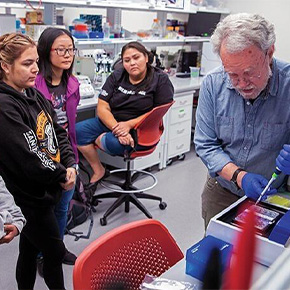 adult with students in lab 