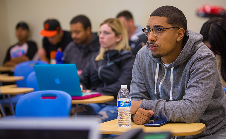 Student sits at desk in classroom