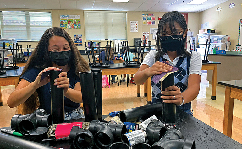 Two students work on STEM project