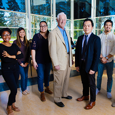  A man poses with students in the VBT building