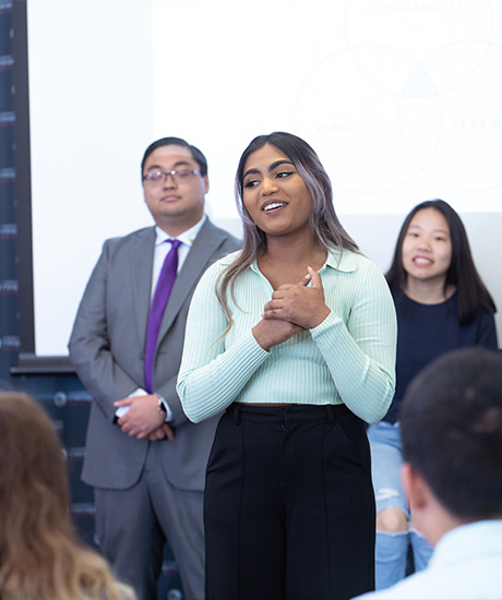 Students presenting business idea in front of audience