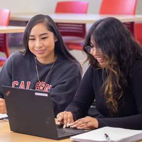 two students sitting down in class 