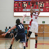 Female basketball player take a shot over opponent