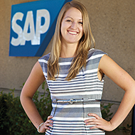 Woman stands in front of SAP sign