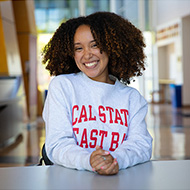 Female student smiling and wearing a CSUEB sweatshirt
