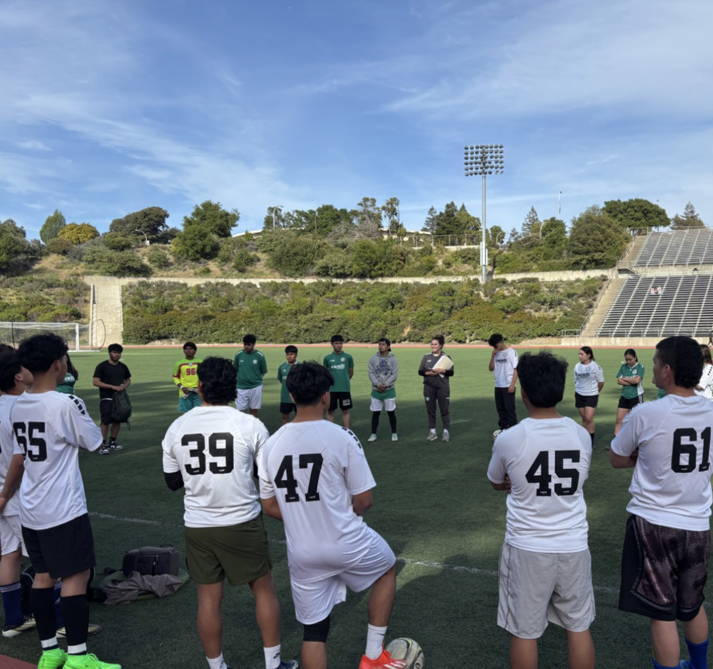 students in a soccer huddle 