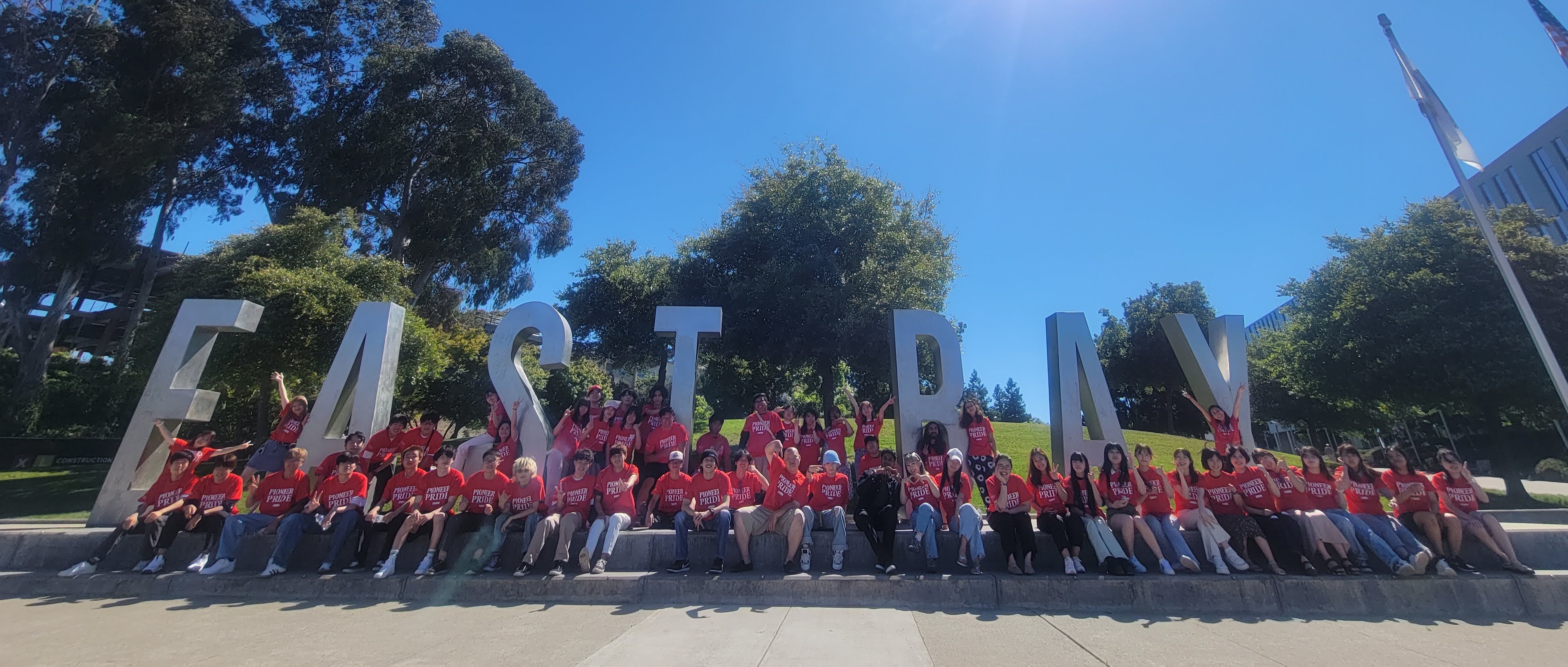 Students at the EAST BAY sign