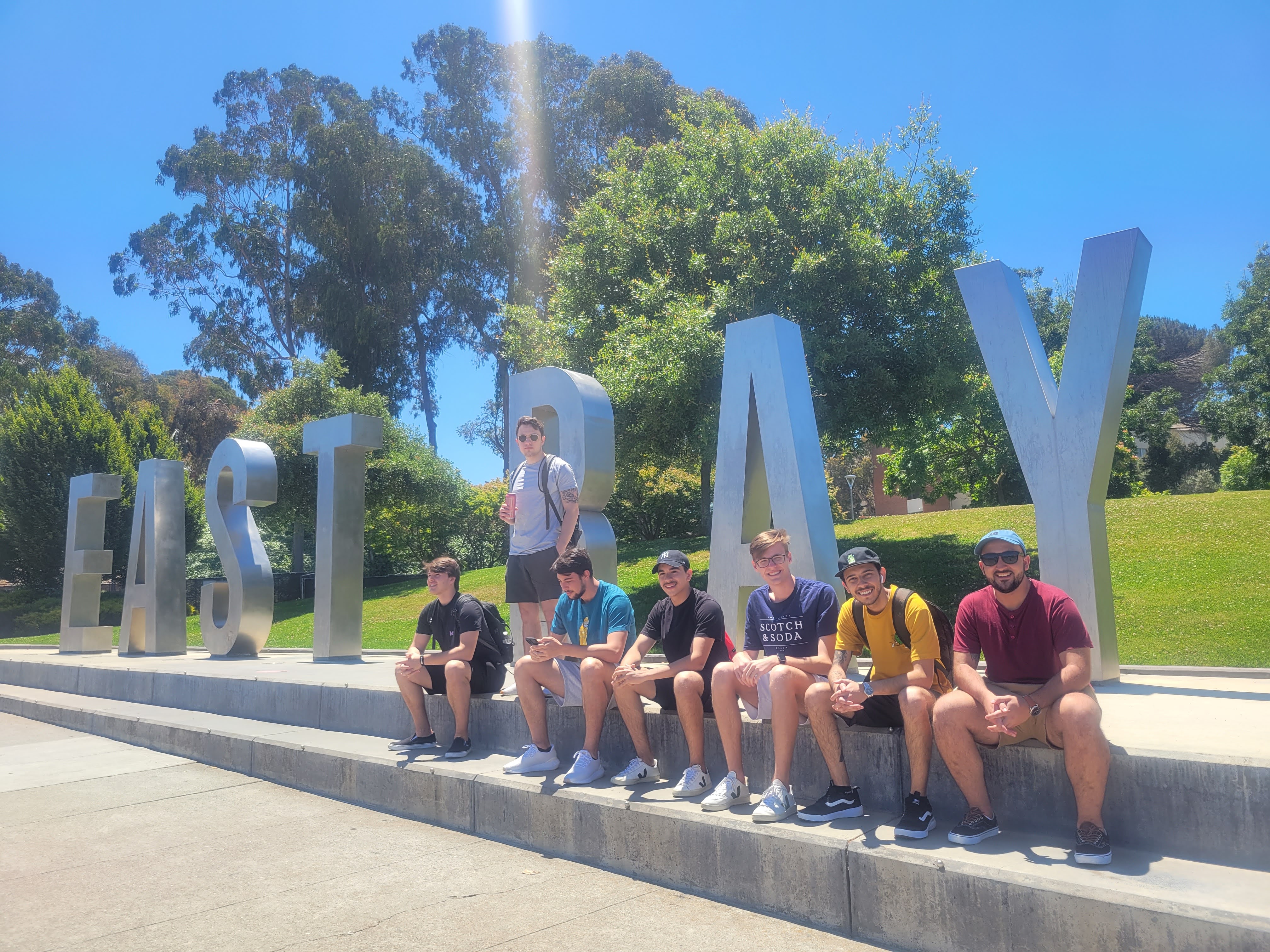 7 students sitting at the EB sign