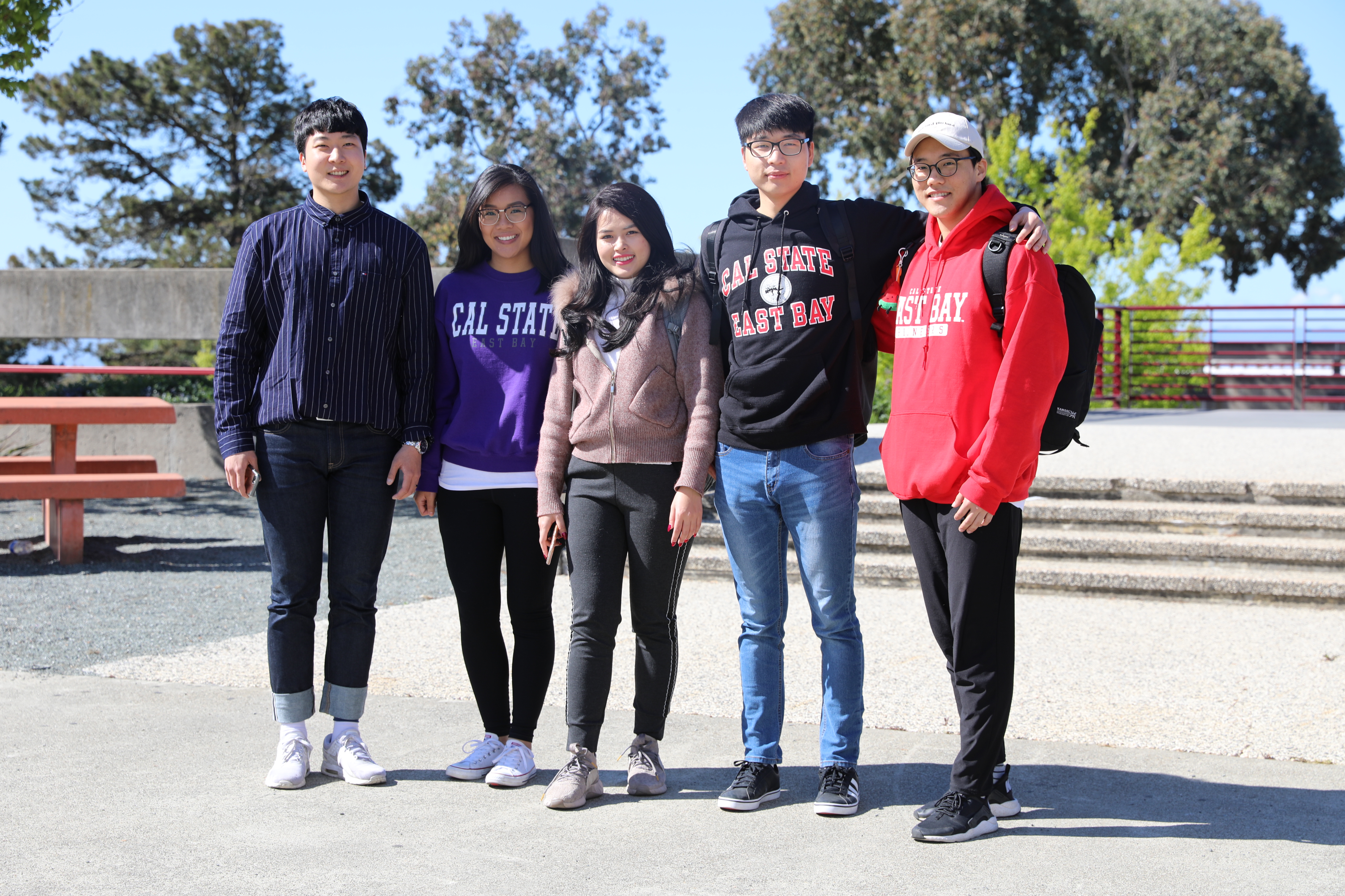 5 students standing on campus