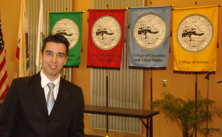 international business student standing in front of college flags