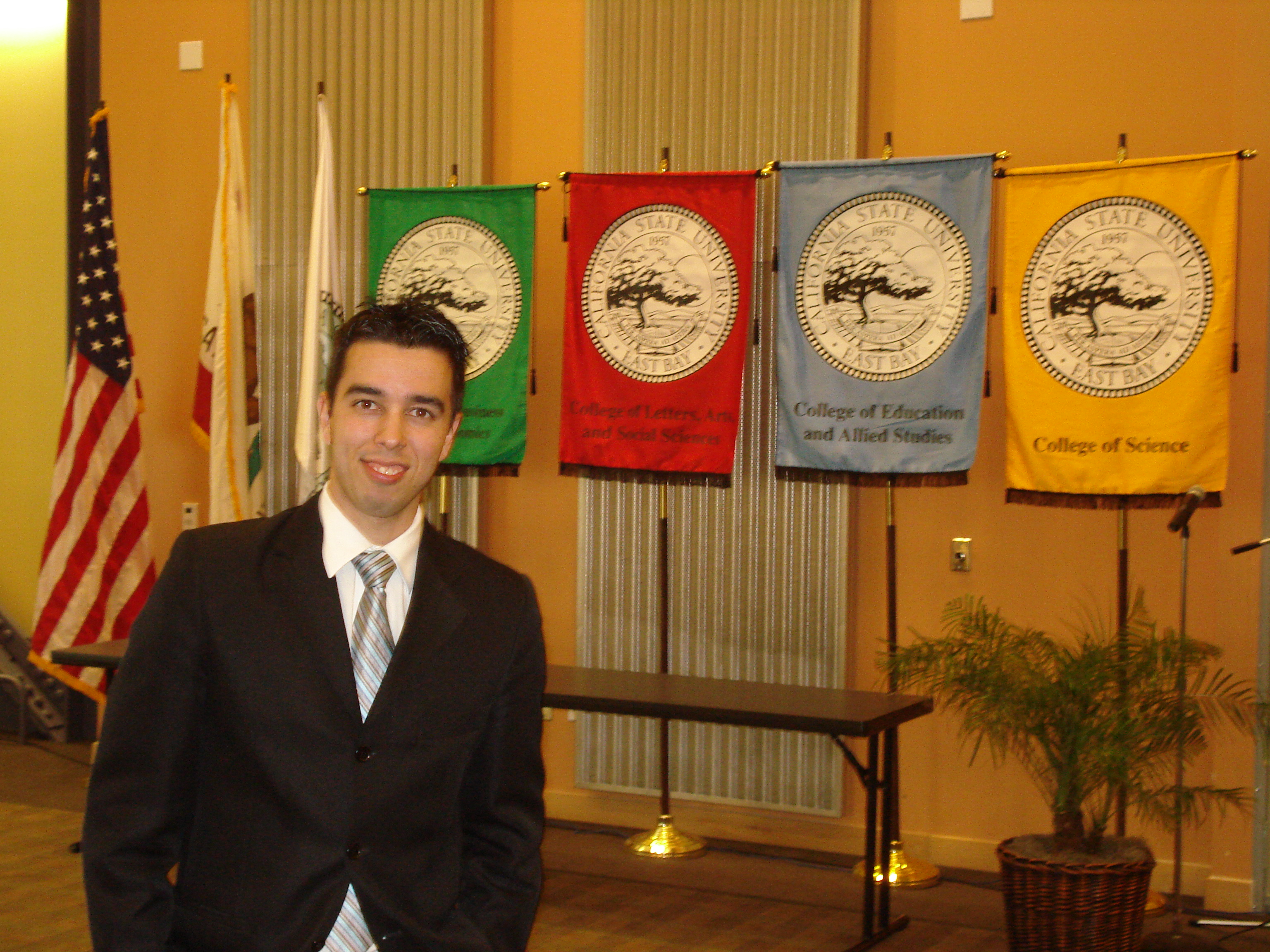 international business student standing in front of college flags