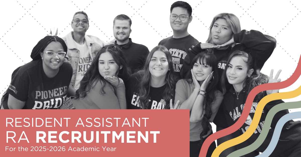 Picture of 4 student leaders wearing Cal State East Bay apparel standing in front of a residence hall with their arms around each other and laughing.