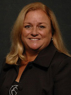 Dr. Melany Spielman in black shirt and black background