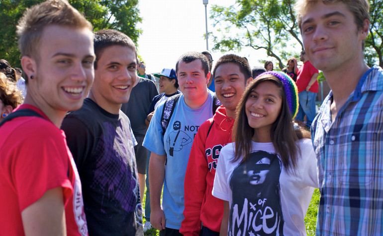 image of happy freshmen students on campus looking at camera