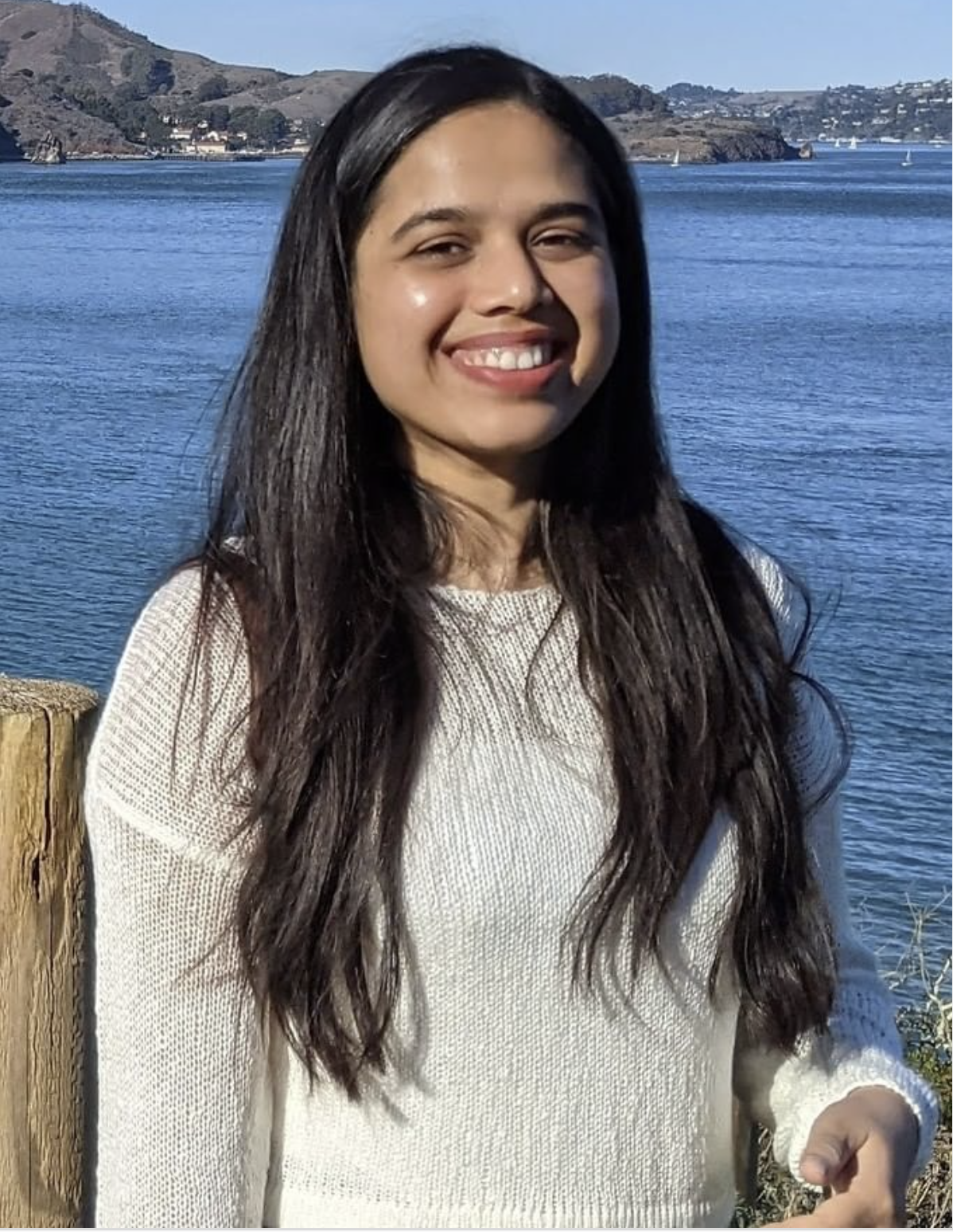 woman smiling at Golden Gate Bridge