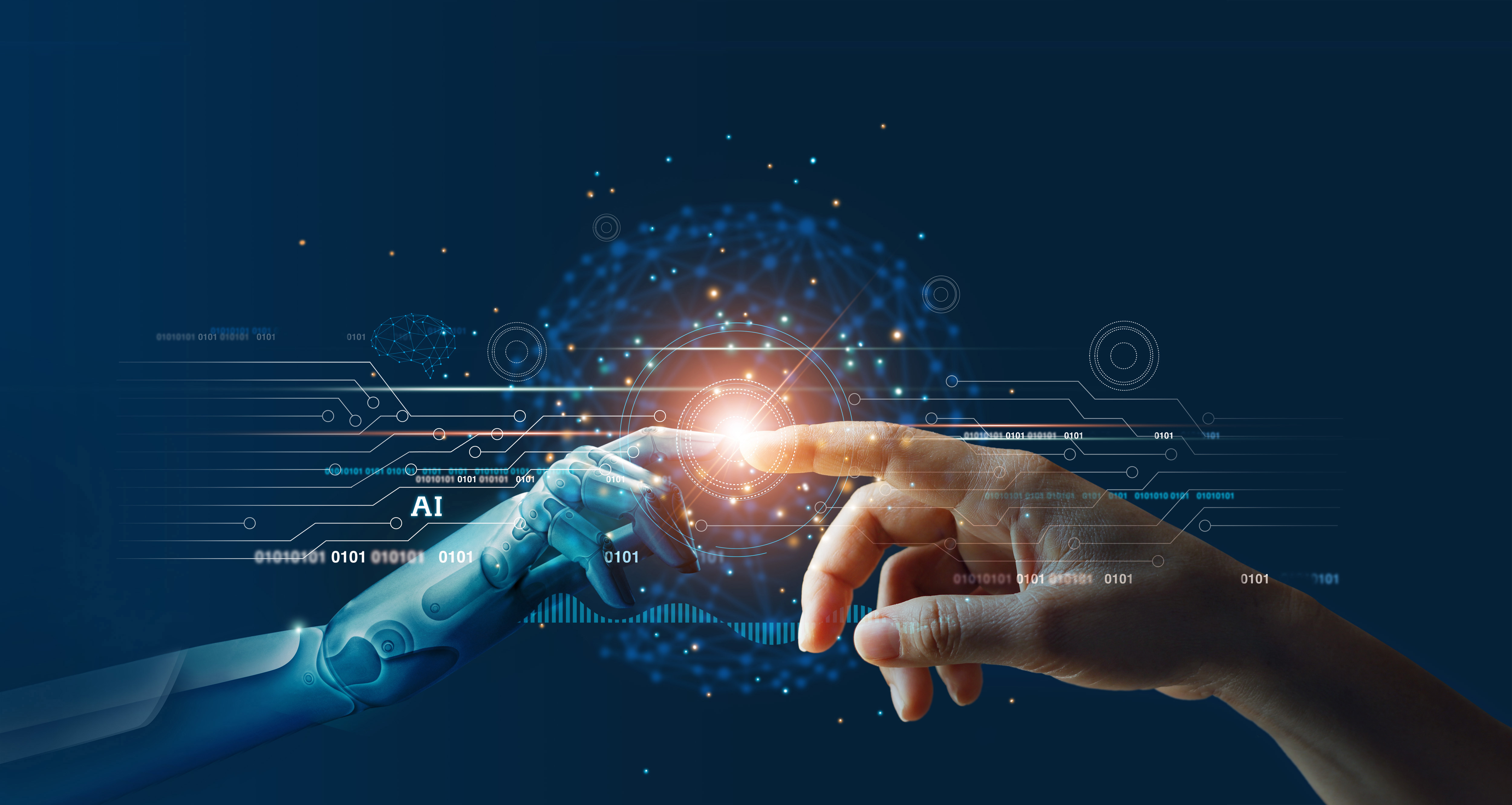 A futuristic image depicting a human hand and a robotic hand reaching out towards each other, with their fingertips nearly touching. A bright glow emanates from the point where their fingers almost meet, symbolizing the connection between humans and artificial intelligence. Surrounding the hands are digital circuit-like graphics and binary code, highlighting the concept of technology and AI integration.