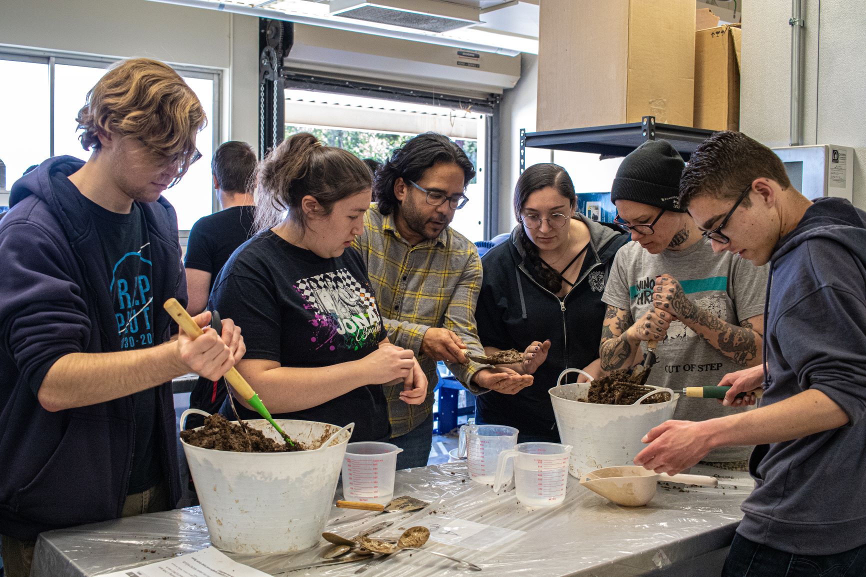 students mixing mud