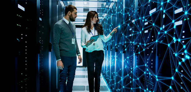 Man and woman walking through a high-tech lab