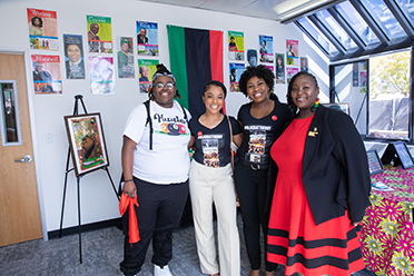 Four people stand in Black Student Resource Center. 