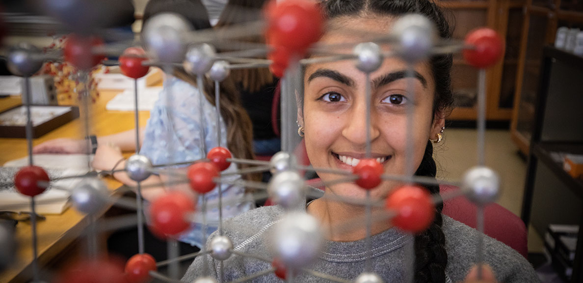 Female stands in science classroom