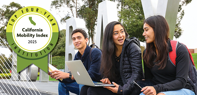 Three students sitting in front of the East Bay monument