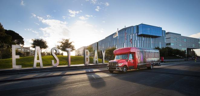 East Bay shuttle parked next to Eats Bay letters
