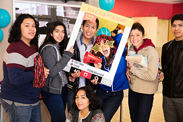 Prospective students putting face in photo frome