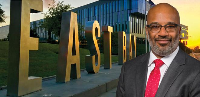 Walt Jacobs in front of East Bay letters