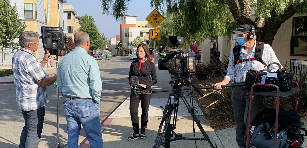 President Sandeen chats with a news crew on campus