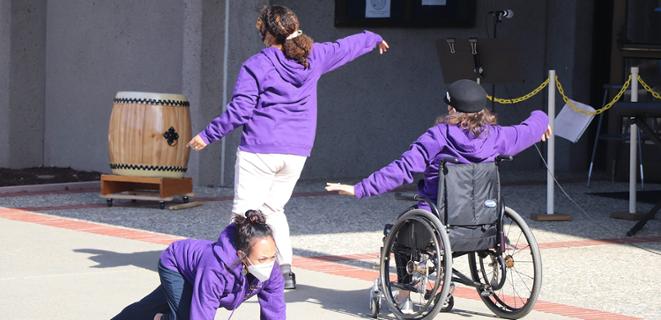 Three performers dancing 