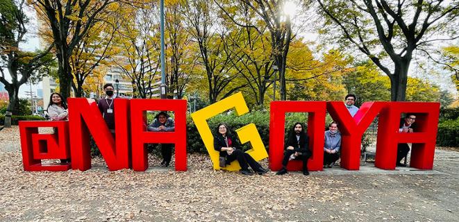 Students standing in front of Nagoya sign