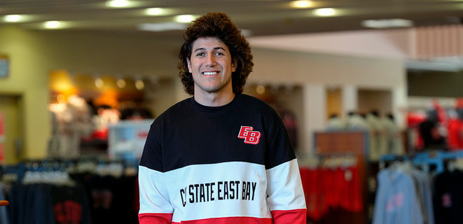 Kyle McCray wearing a Cal State East Bay sweatshirt
