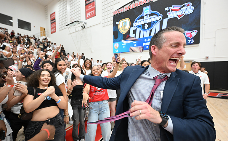Men’s Basketball Head Coach Bryan Rooney celebrating with the Pioneer audience