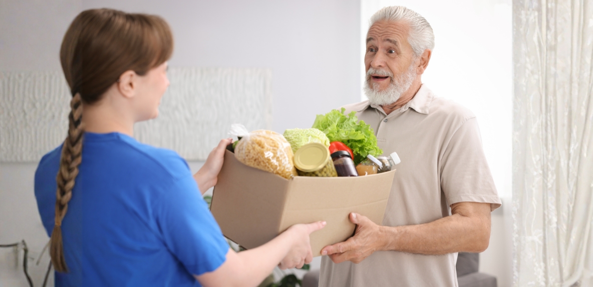 Volunteer delivering food to a senior citizen