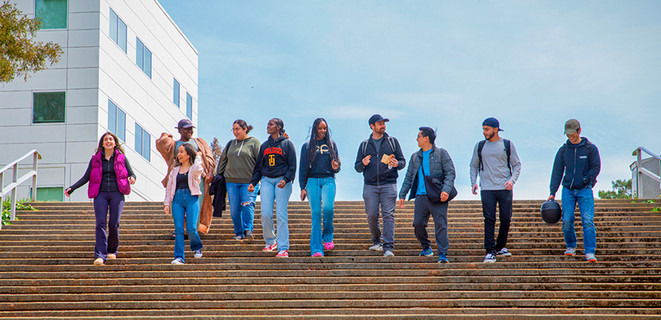 A diverse group students walking down the steps together at Cal State East Bay's Hayward campus