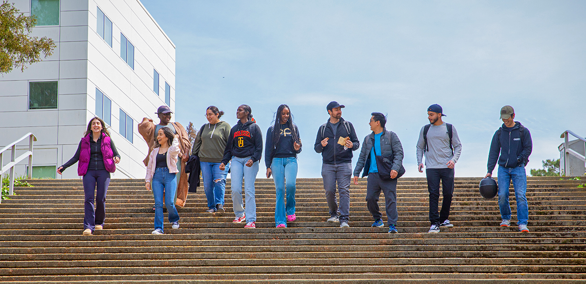 A diverse group students walking down the steps together at Cal State East Bay's Hayward campus