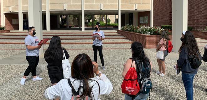 Students at orientation stand outside music building