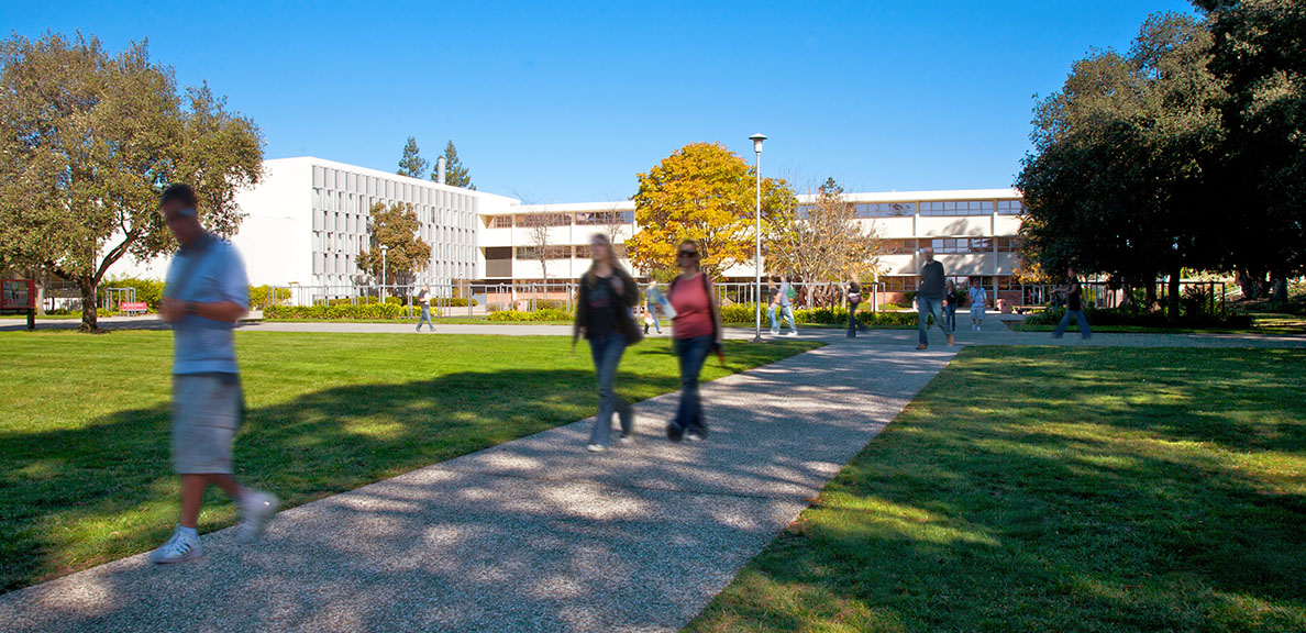 People walk in front of the Arts and Education building at CSUEB