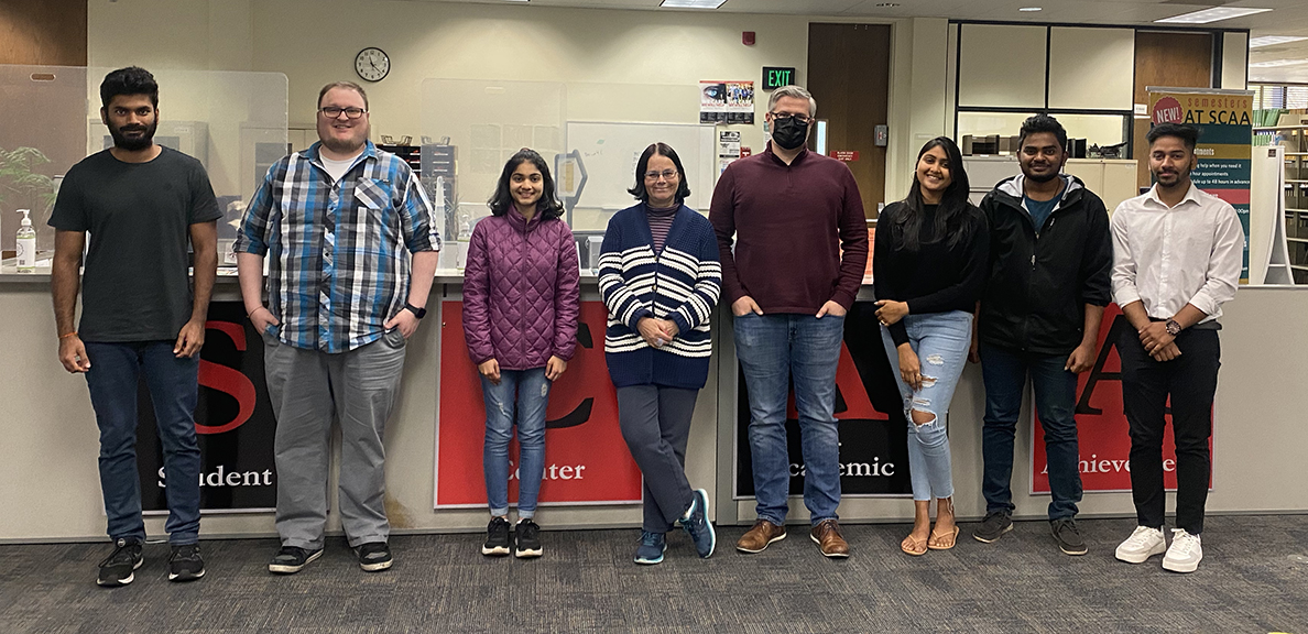 Members of the SCAA pose for a group photo in the library