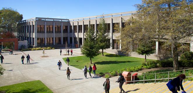 Students walking by the old university library building