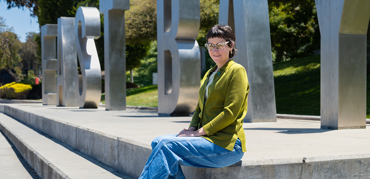 Colleen Garland sitting in front of the East Bay monument